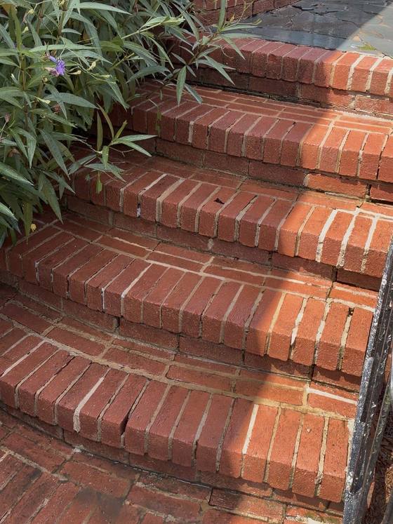 The same brick steps after cleaning: the brick has come back to a bright red and the mortar joints are clean and pale again.